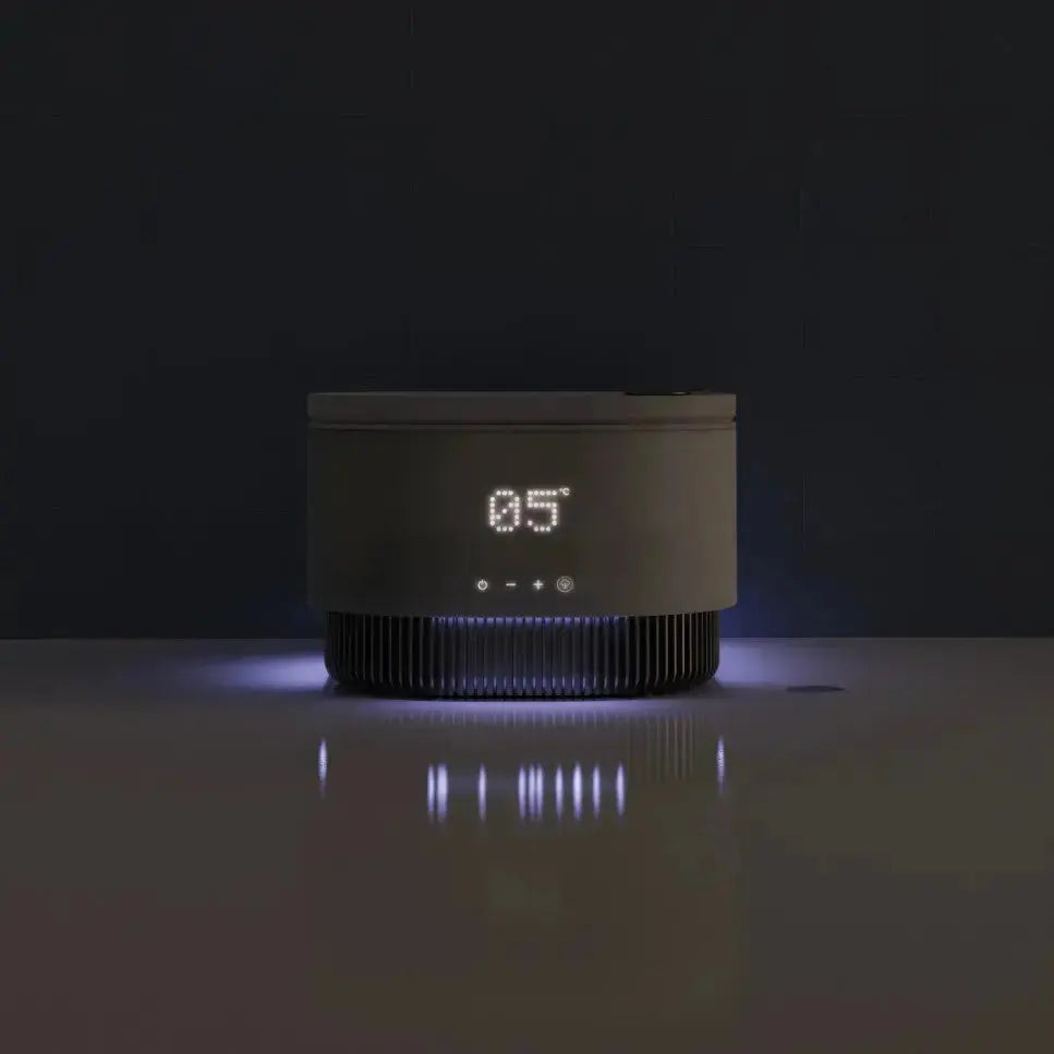 Frosteam skincare device illuminated on dark background