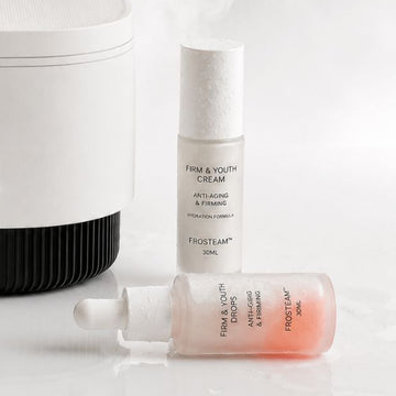Frosteam device releasing steam beside Firm & Youth Cream and Drops serum