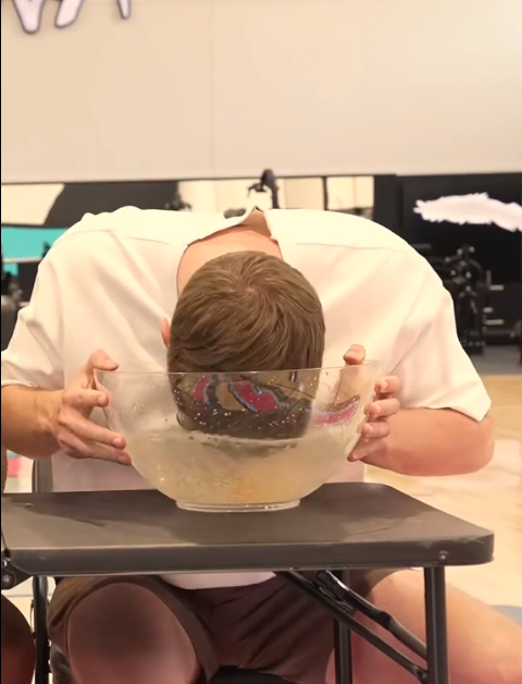 MrBeast dipping his face into an ice bowl, showcasing the viral ice facial trend reimagined by Frosteam 3-in-1.