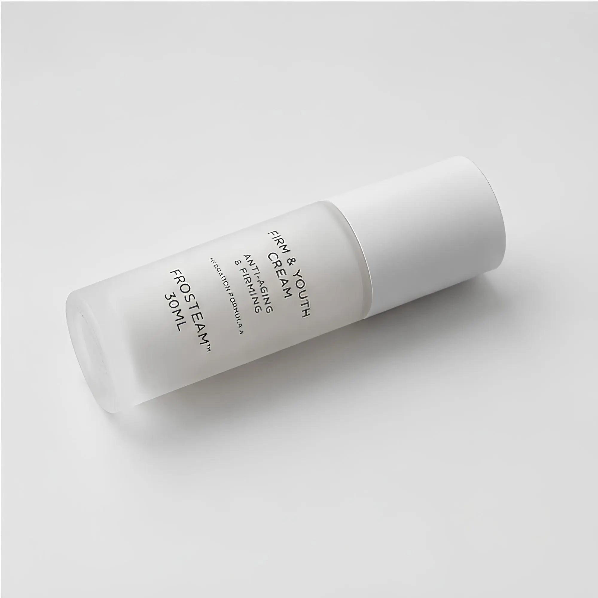 Frosteam Firm and Youth Cream bottle lying diagonally on white background