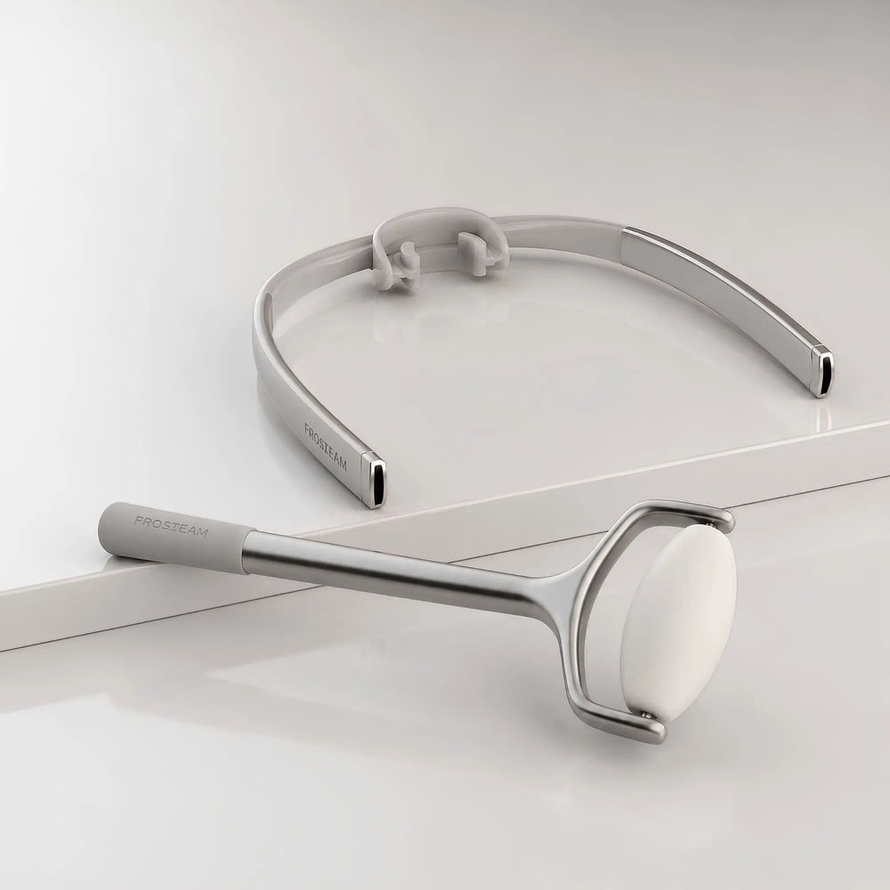 Frosteam Face Roller and Dive Breather luxury facial skincare tools on a minimalist light gray studio background.