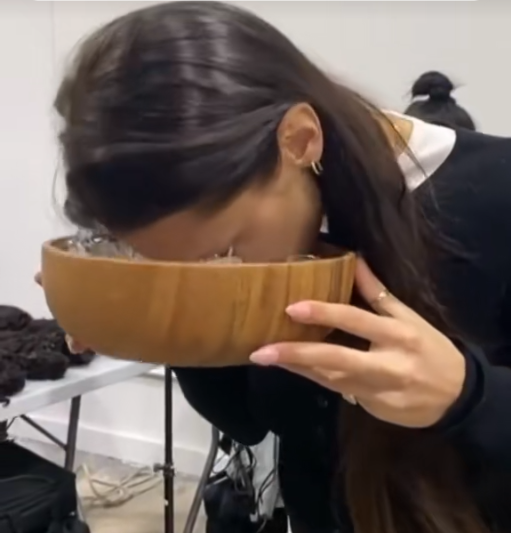 Bella Hadid performing facial ice plunge to depuff skin and improve circulation, a celebrity cold therapy beauty ritual