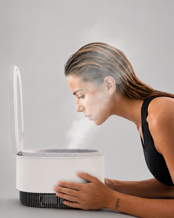 Woman experiencing nano-ionic steam from the Frosteam Harmony device