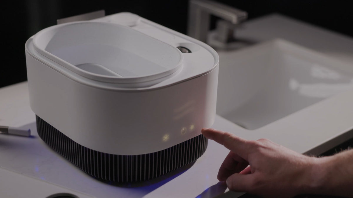 Finger touching the lit LED touch panel on the front of Frosteam Harmony