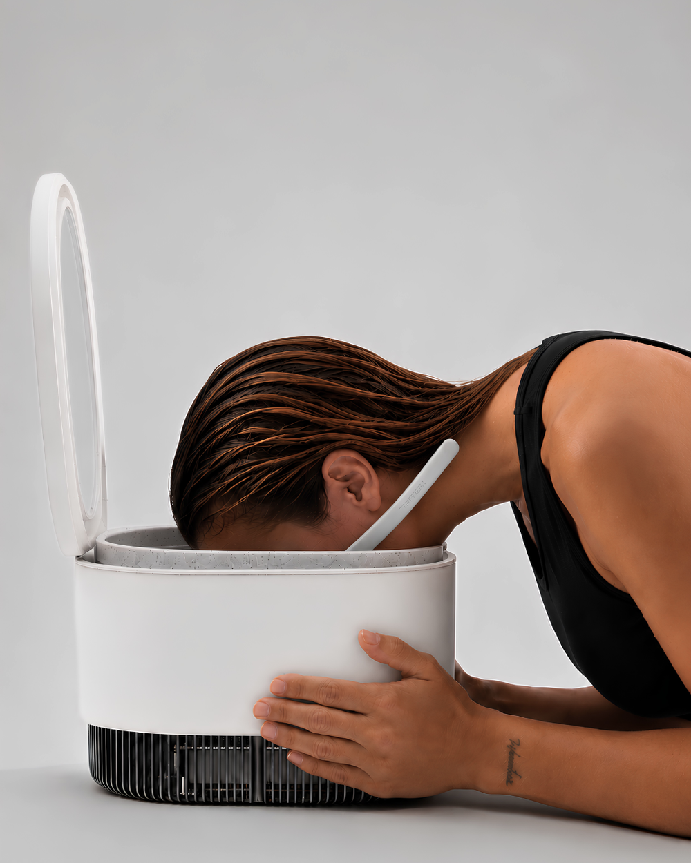 Woman using the Frosteam Dive Breather mouthpiece during cold immersion