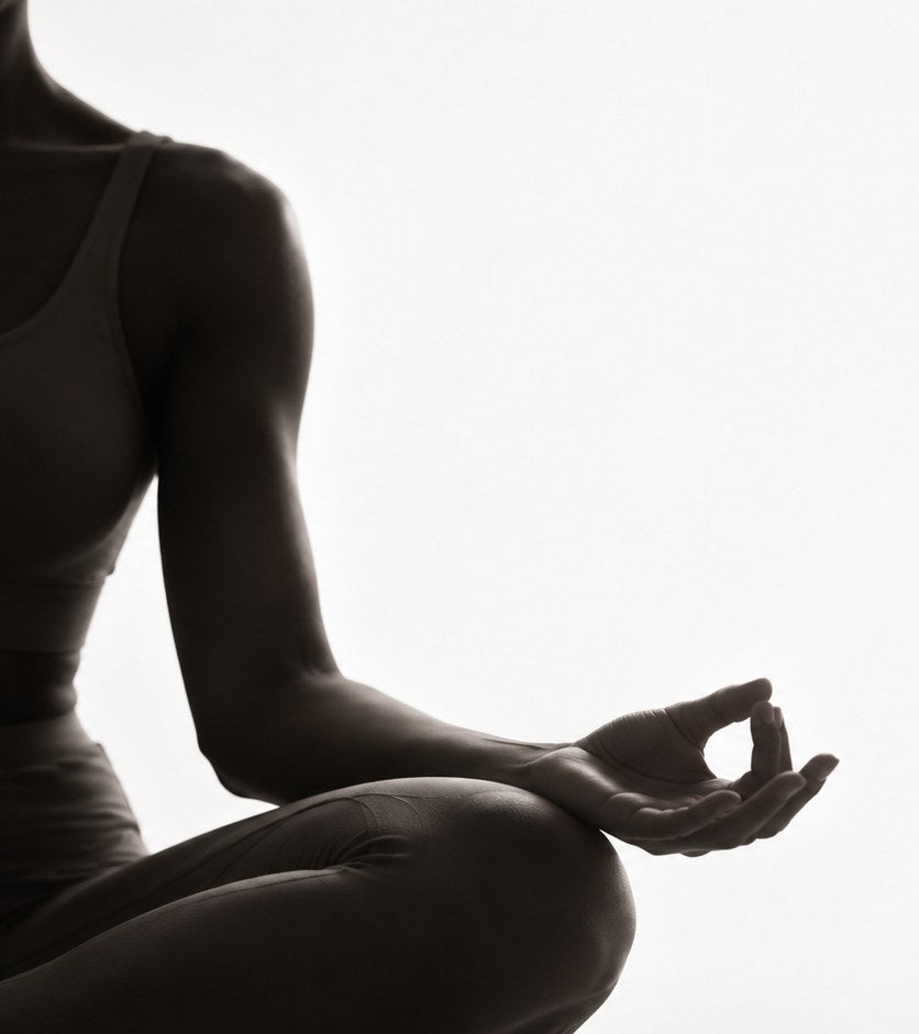 Woman in a calm meditation pose, representing the wellness side of the Frosteam Harmony ritual