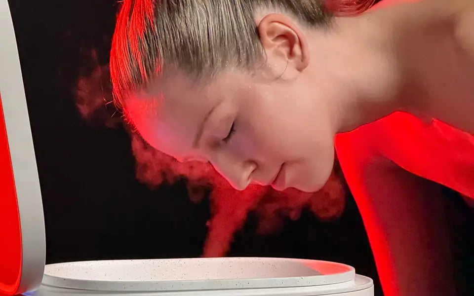 Woman relaxing over warm steam rising from the Harmony basin